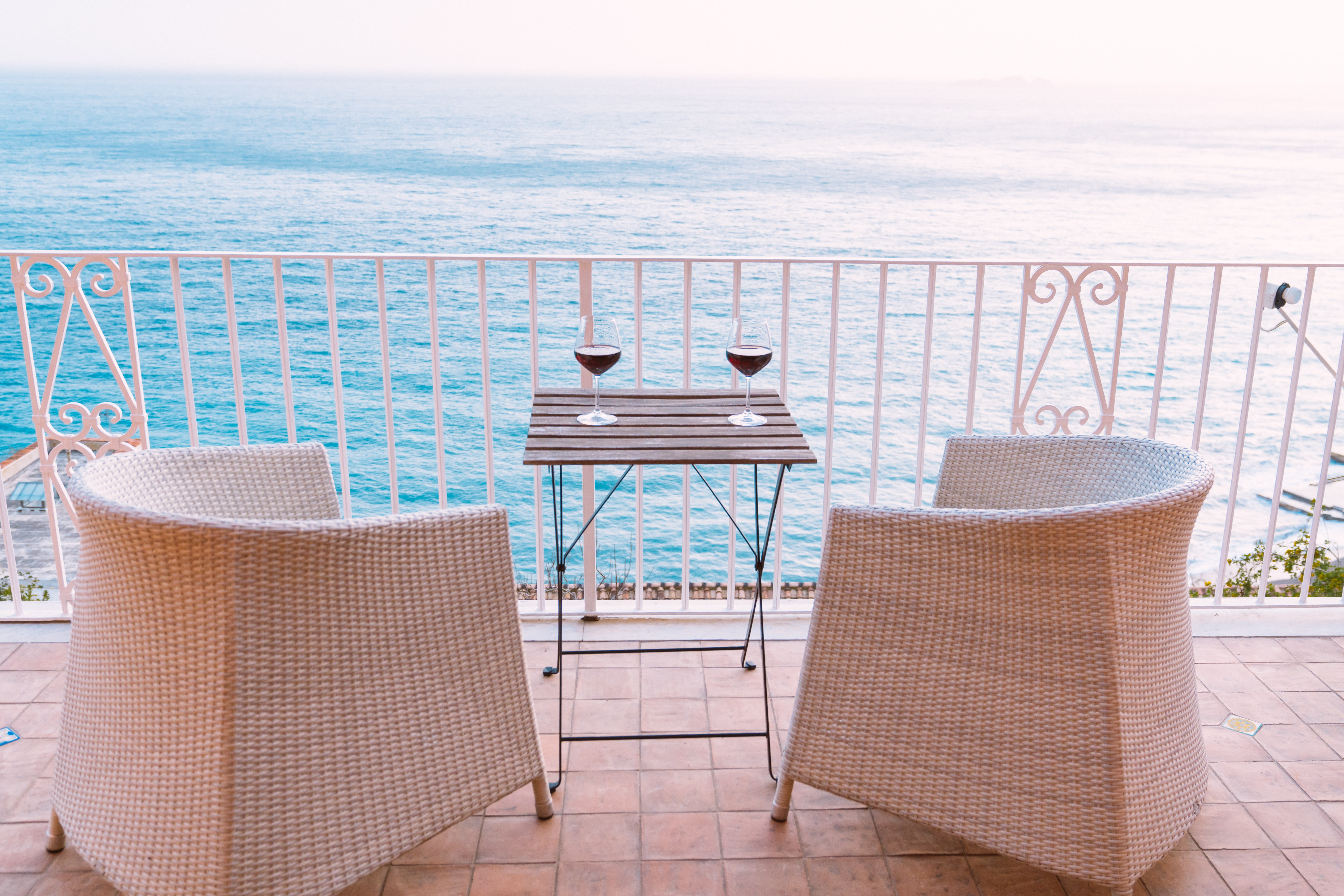 two chairs on a hotel patio overlooking the water