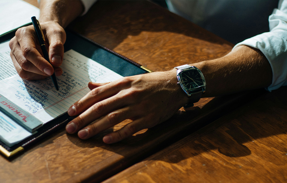 Jotting down ideas in a notebook